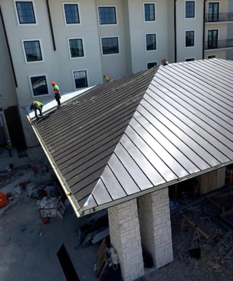 Crew installing standing seam metal roof panels on a commercial project in Selinsgrove